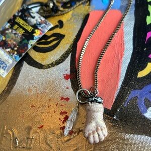 Antique repurposed doll fist necklace